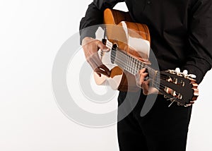 Isolated classical guitar and guitarist`s hands up close on a white background