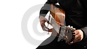 Isolated classical guitar and guitarist`s hands up close on a white background