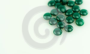 Isolated close up of green pills with copy space
