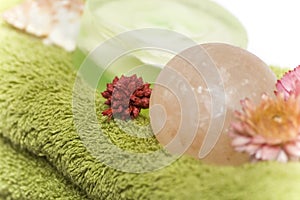 Isolated close-up of spa towels, soaps and flowers