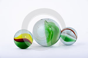Isolated closeup of glass marbles on white background