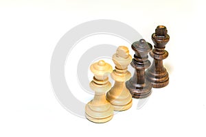 Isolated closeup to chess pieces over white background. Represent teamwork, strategy, power, battle, logic game.