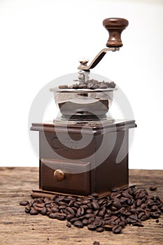 Isolated coffee bean grinder next to fresh coffe bean