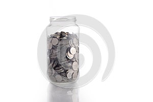 Isolated coin in glass jar