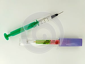 Isolated color mercury thermometer and green and white cannula