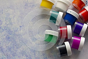 Isolated colored acrylic paints in the plastic bottles