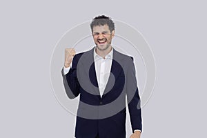 Isolated confidence hispanic businessman with fist up posed