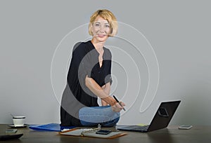 Isolated corporate business portrait of young beautiful and happy woman with blonde hair smiling while working relaxed at office l