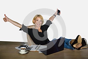 Isolated corporate business portrait of young beautiful and happy woman with blonde hair working relaxed at office laptop computer