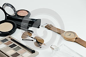 Isolated cosmetic object, powder, glasses, perfume and watch on