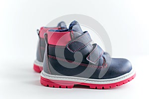 Isolated dark blue with pink children leather shoes on a white background