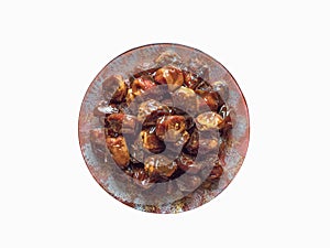 Isolated dates in bowl with syrup. Iftar dates