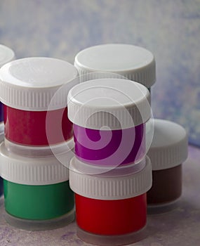 Isolated colored acrylic paints in the plastic bottles