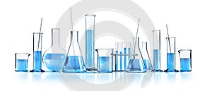 Isolated different laboratory glassware with blue liquids