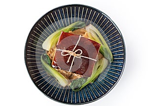 Isolated Dong Po Rou Dongpo pork meat in a beautiful plate with green vegetable photo