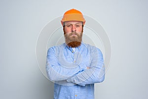 Isolated doubter architect with beard and orange helmet