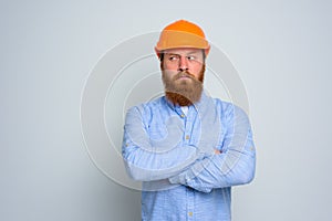 Isolated doubter architect with beard and orange helmet