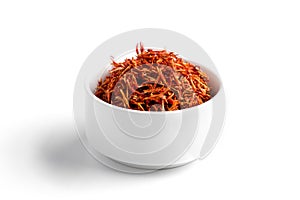 Isolated dried spice saffron in a white bowl