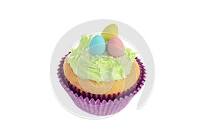 isolated easter cupcake with coconut frosting and mini chocolate eggs