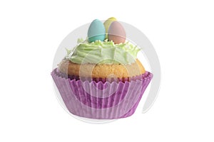 Isolated easter cupcake with green frosting and mini eggs