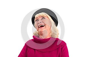 Isolated elderly female laughing.