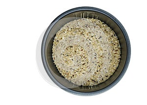 Isolated electric rice cooker with raw mix brown rice inside, top view electric rice cooker with brown rice on white background.