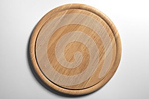 Isolated empty round wooden chopping board