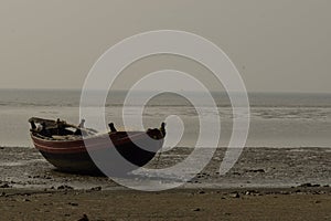 An isolated fishing boat beached on Kargil seabeach near Frezargunj, Westbengal, India