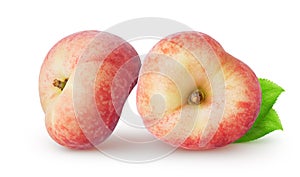 Isolated flat peaches. Two whole peach fruit with leaves isolated on white background.