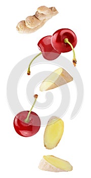 floating cherry fruits and ginger isolated on white background photo