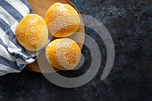 Isolated fresh homemade burger breads on a dark blue background