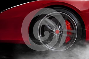 Isolated generic red sport car with detail on wheel with red breaks drifting and smoking on a dark background