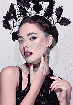 Isolated glamour close-up fashion/beauty portrait of a beautiful caucasian girl wearing perfect make-up and unusual accessories