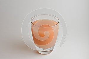 Isolated Glass of fresh pink Grapefruit juice