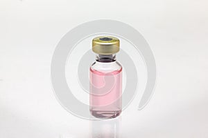 Isolated glass vaccine bottle with colored liquid very close high magnification mockup
