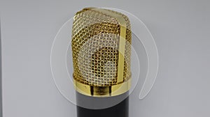 An isolated golden open mic for professionals, stand up comedians. Condenser mics