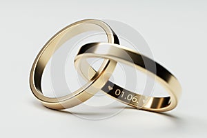 Isolated golden wedding rings with date 1. June