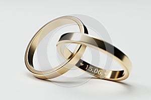 Isolated golden wedding rings with date 15. June