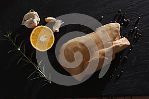 ISOLATED GOOSE LIVER ON BLACK BACKGROUND. GASTRONOMY STILL LIFE PHOTO. FOIE GRAS GOURMET FOOD.