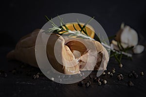 ISOLATED GOOSE LIVER ON BLACK BACKGROUND. GASTRONOMY STILL LIFE PHOTO. FOIE GRAS GOURMET FOOD.