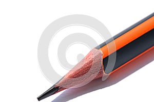 Isolated graphite simple pencil with orange and black pen on white background close-up