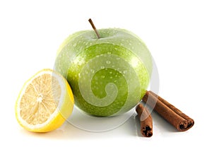 Isolated green apple and lemon with cinnamon pods