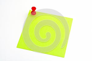 Isolated green paper with red pushnail