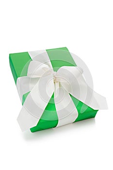 Isolated green present tied with white ribbon for Christmas