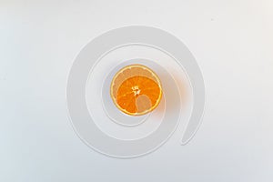 Isolated half orange in a white background. Flat lay, copy space, advertisement