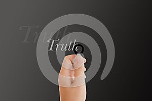 Isolated hand with lens and text truth on dark platinum background