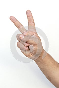 Isolated hand signal on white background, male adult hand making a two fingers peace sign