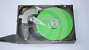 Isolated hard drive from the computer with a green disc.