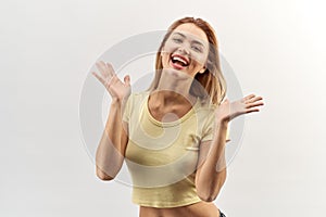 Isolated high contrast Studio portrait of happy joyful young woman girl in yellow shirt with rapturous emotions