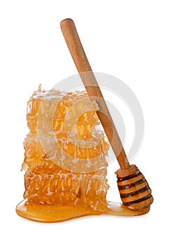 Isolated honey. Honeycomb beeswax with fresh liquid yellow honey and dipper spoon on white background